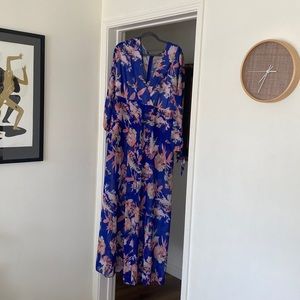 Floral long sleeved romper with long train/sort attached.